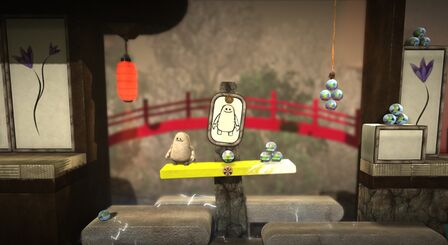 Toggle weighing down a seesaw. Official screenshot from the LittleBigPlanet Twitter account.[1]