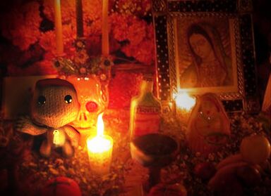 A concept image of Sackboy edited onto a photo of a Day of the Dead altar.